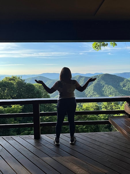 Woman with arms wide at overlook